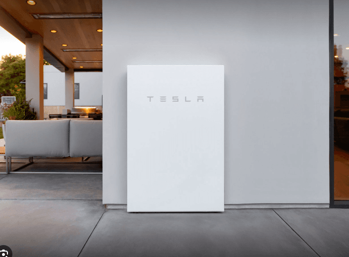 Tesla Powerwall home battery mounted on a modern home exterior